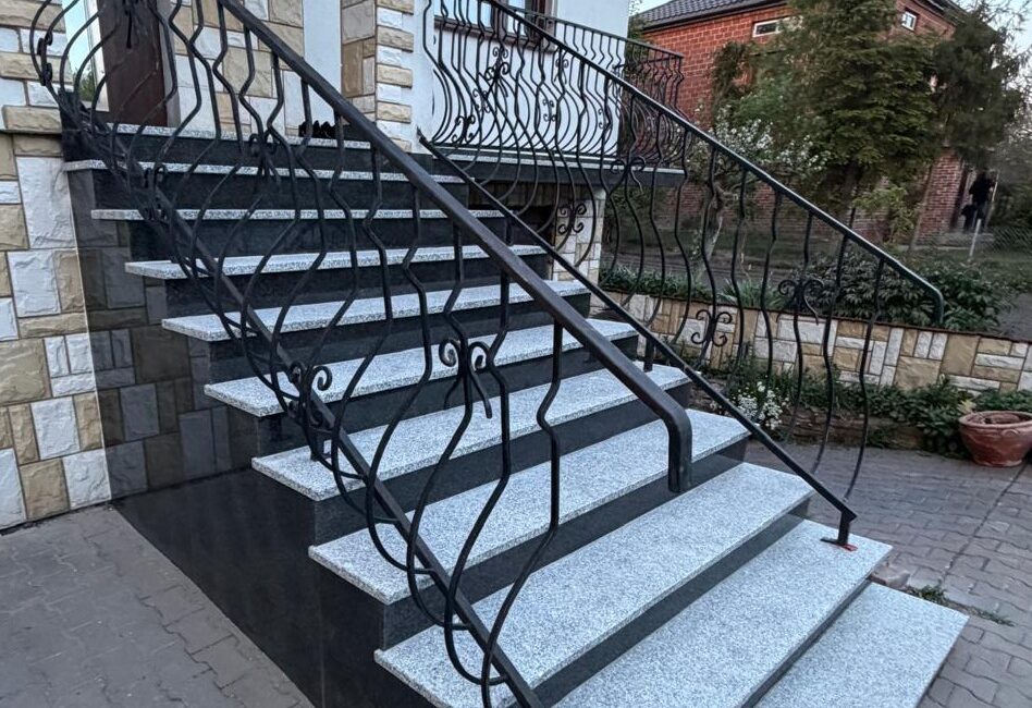 Zewnętrzne schody z jasnymi stopniami i ciemnymi podstopnicami